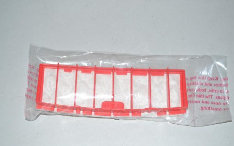 A red plastic replacement filter element inside a clear plastic bag with printed red text, photographed on a light gray background.