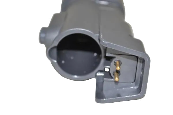 A close-up of a gray plastic electrical connector with two gold-colored pins visible inside the open terminal, set against a plain off-white background.