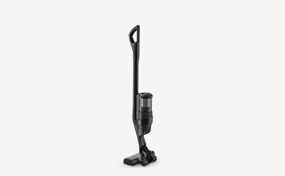 A cordless stick vacuum cleaner in black, shown from a side profile against a solid off-white background.