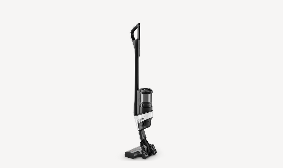 A cordless stick vacuum cleaner with a black and silver body, shown from a side profile against a solid light gray background.