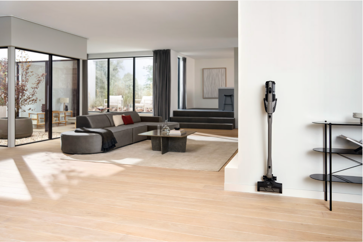 Modern living room with a vacuum cleaner on a white wall.