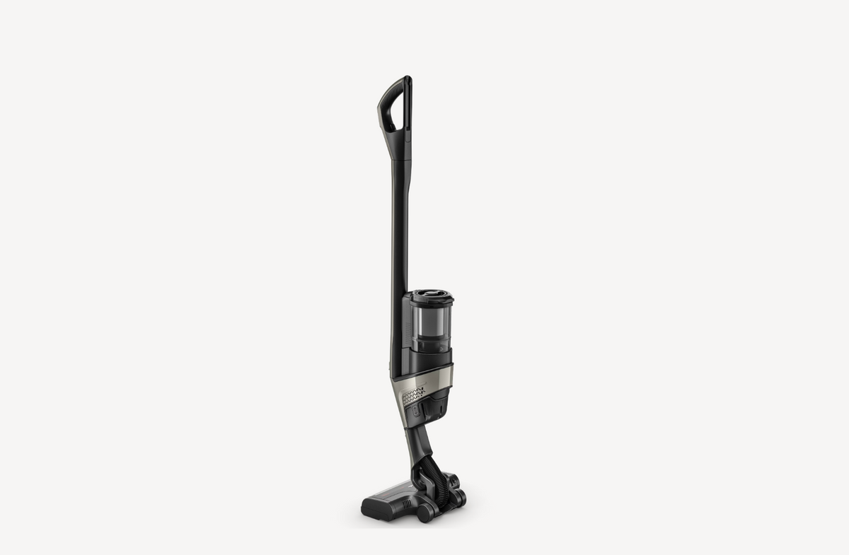 A cordless stick vacuum cleaner with a black body and silver accents, shown from a side profile against a light gray background.