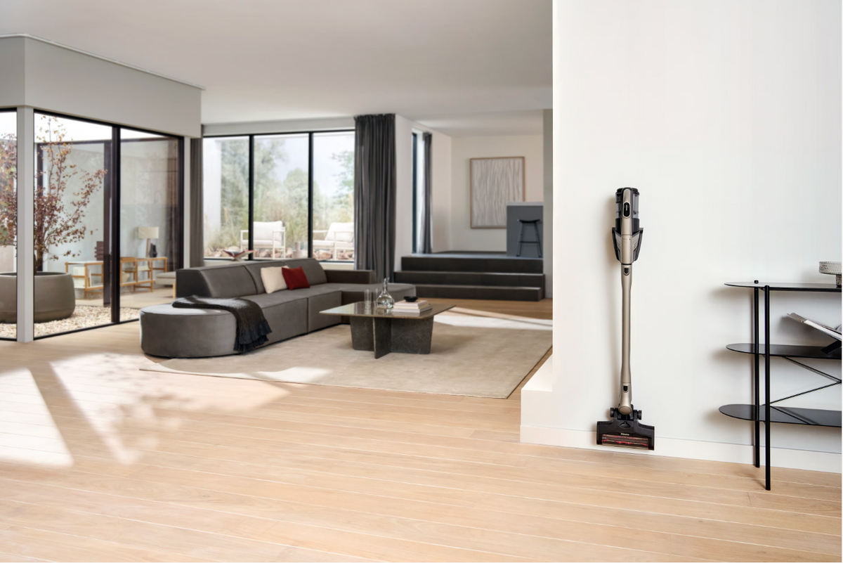 Modern living room with a vacuum cleaner on a wooden floor