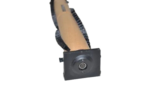 A close-up of a small black square camera or sensor module with a circular lens opening, attached to a tan cylindrical handle wrapped in a black strap, photographed on a plain light background.